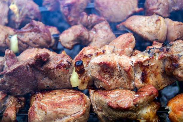 istock Appetizing shish kebabs in the smoke, preparing on the grill 1201143766