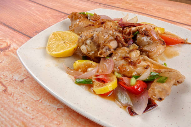 istock Lemon chicken on wooden background. 1201144109