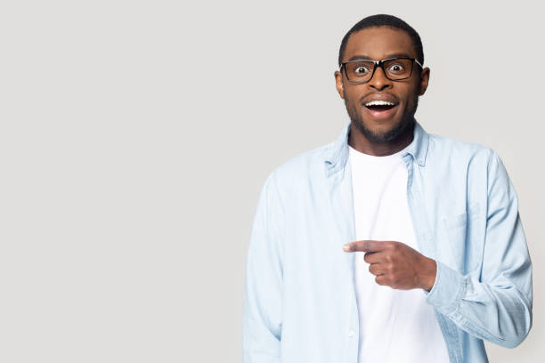 istock Excited black man point at blank copy space aside 1201144327