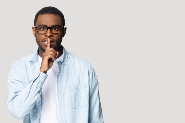 istock Black male aside blank copy space tell secret 1201144333