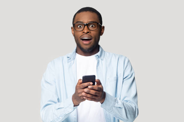 istock Surprised black male excited by message on smartphone 1201144334
