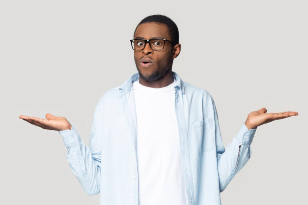 istock Doubtful black male compare options making choice 1201144343