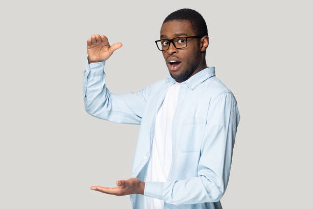 istock Amazed black male show big size measurement with hands 1201144349