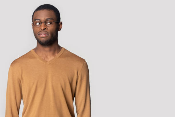 istock Pensive black man in glasses look at blank copy space 1201144391