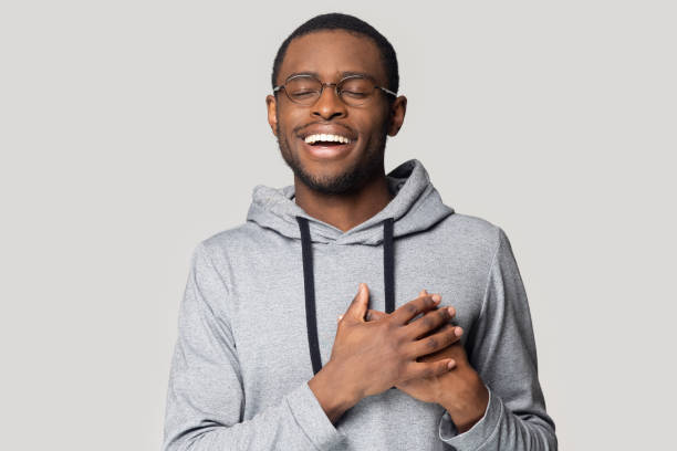 istock Grateful black male believer touch heart feel thankful 1201144408