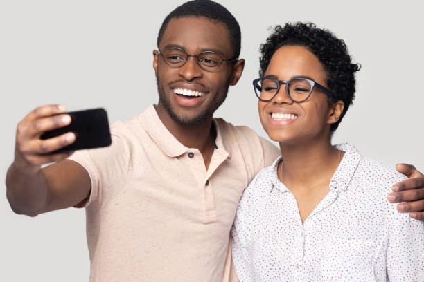 istock Smiling ethnic couple hug posing for selfie together 1201144539