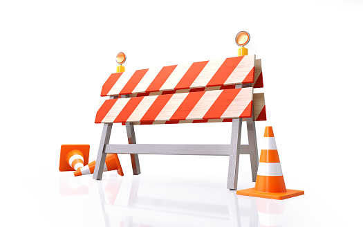 Orange colored traffic cones and construction barrier on white background. Horizontal composition with clipping path and copy space.