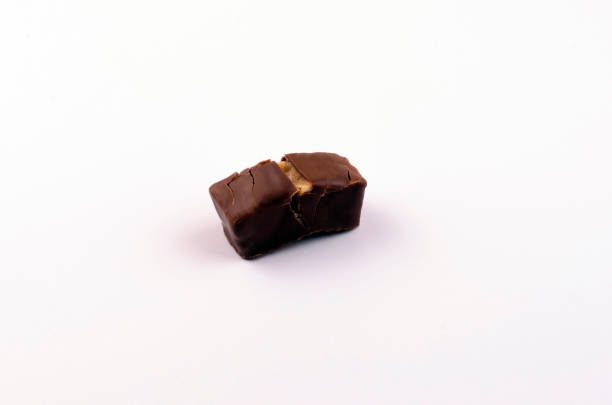 istock chocolate candies with nuts and caramel on a white background 1201144851