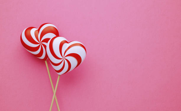 istock Valentine's Day Concept- Heart Shaped Lollipops on Pink Background 1201145659