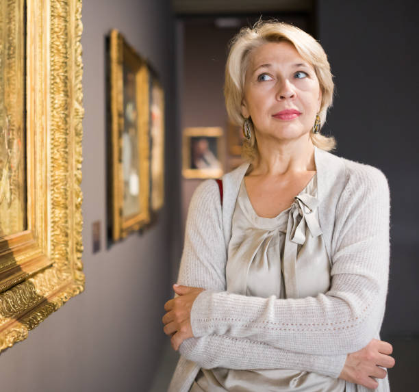 istock Female visitor looking at artwork painting 1201146506