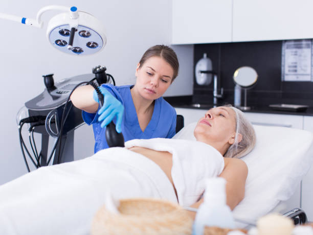 istock Cosmetician performing hardware body treatment 1201147805