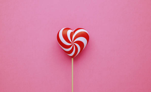 istock Valentine's Day Concept- Heart Shaped Lollipop on Pink Background 1201148814