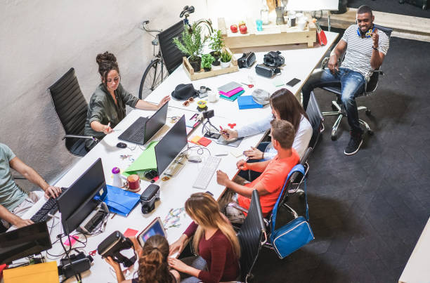 istock Young co-workers team talking during startup - Happy people planning a new project in creative workplace office - Technology, entrepreneur, marketing and concept - Focus on center girls heads 1201152630
