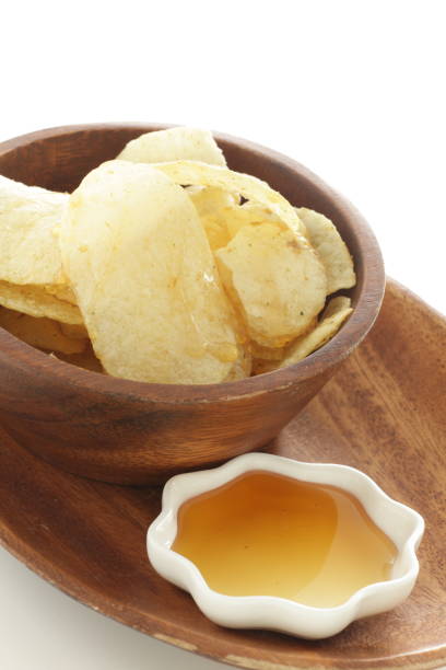 istock Potato chips and honey for snack food time 1201153031