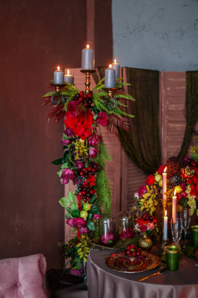 istock Table decorated with artificial fruits and candles 1201154891