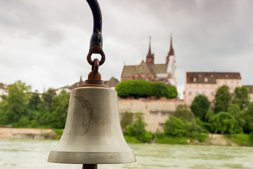 Signal bell at the crossing of the river Rhine in front of the Cathedral in the Swiss city of Basel. Focus concept.