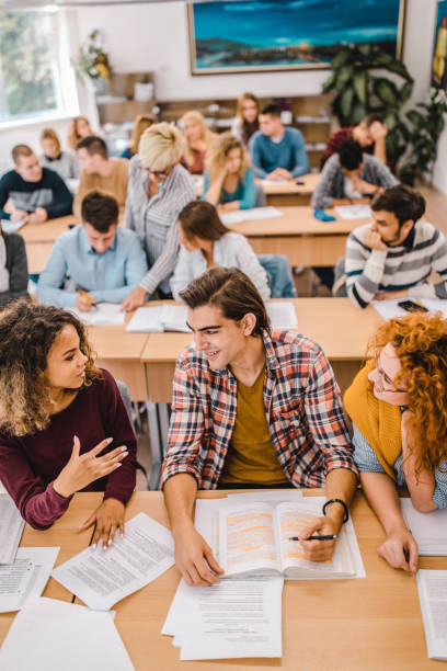 istock Above view of happy university students learning together in the classroom. 1201156392