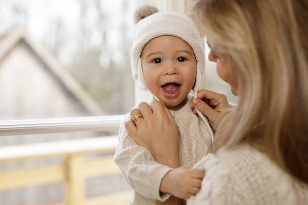 istock Mother put a knitted hat on her baby boy 1201156496