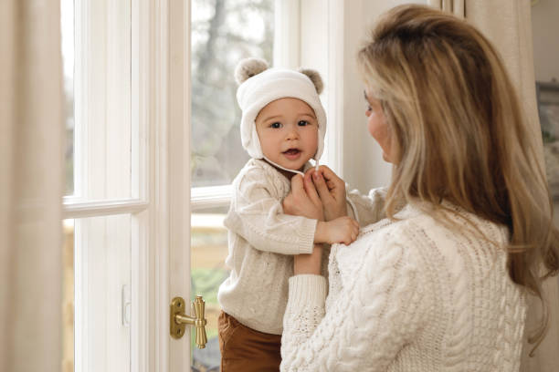 istock Mother put a knitted hat on her baby boy 1201156529