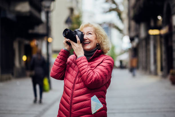 istock Charismatic older lady taking a photo 1201156765