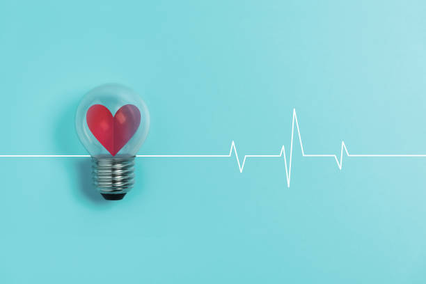 istock Red heart in light bulb with Heartbeat pulse on blue background. 1201157097