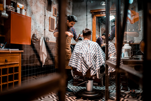 A hairdresser cutting hair and brushing it in a hair salon.