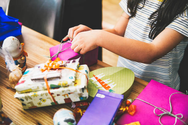 istock little girl unwrapping pink easter gift box 1201159859