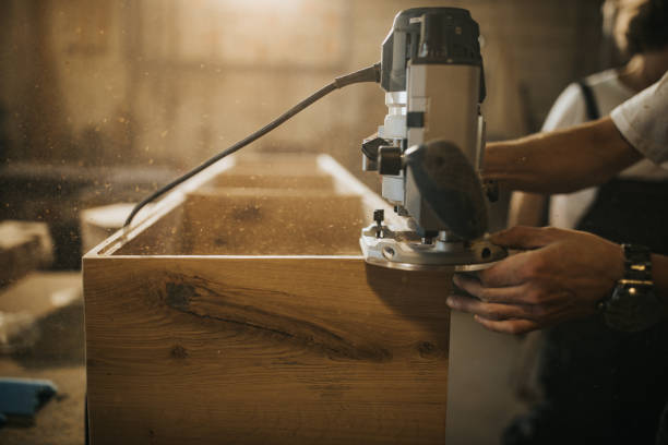 istock Close up of a carpenter using plane while working on a wood in a workshop. 1201159923