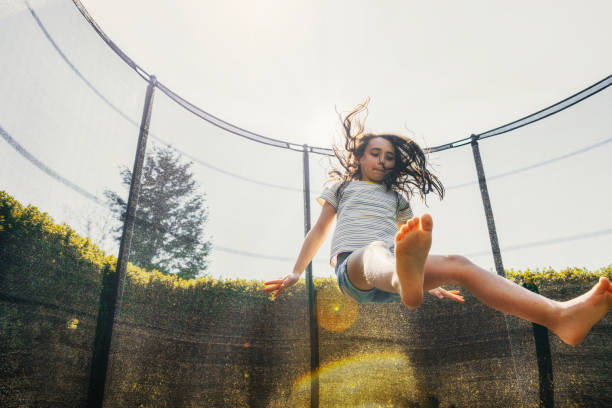 istock little girl jumping on trampoline 1201160978