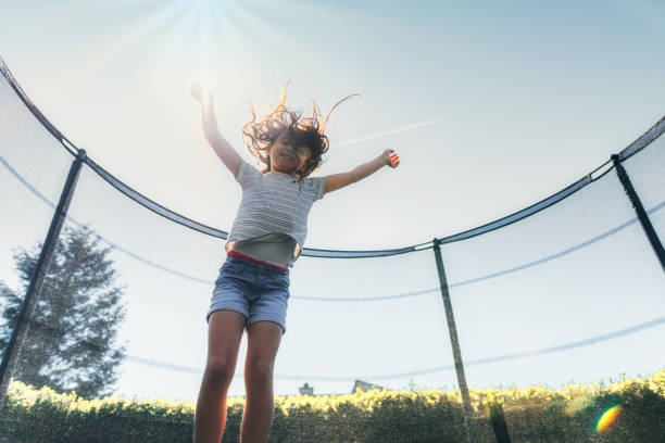 istock happy little girl jumping on trampoline 1201161861