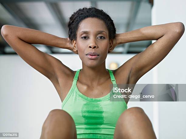African Woman Doing Series Of Crunch In Gym Stock Photo - Download Image Now - Sit-ups, Women, Gym