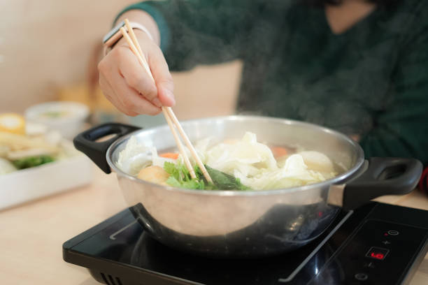 istock Woman boiled vegetables in a boiling pot 1201163865