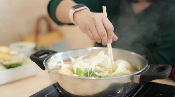 istock Woman boiled vegetables in a boiling pot 1201163877