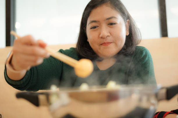 istock Woman boiled meatballs in a boiling pot 1201163910