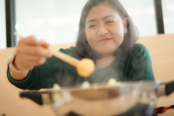 istock Woman boiled meatballs in a boiling pot 1201163920