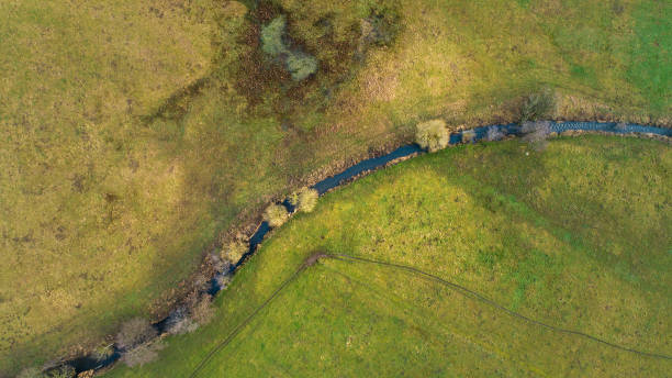 istock Creek flows through a landscape - aerial view 1201166193