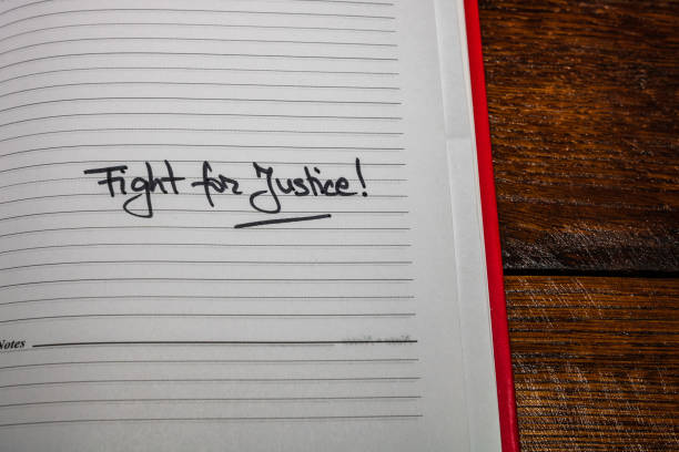 istock Fight for justice, handwriting text on page of office agenda. Copy space. 1201166679