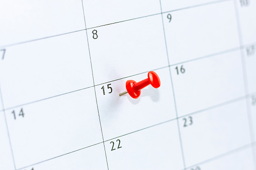 15 date pinning on calendar with Red color pin thumbtack. Save the Date. concept tax day.