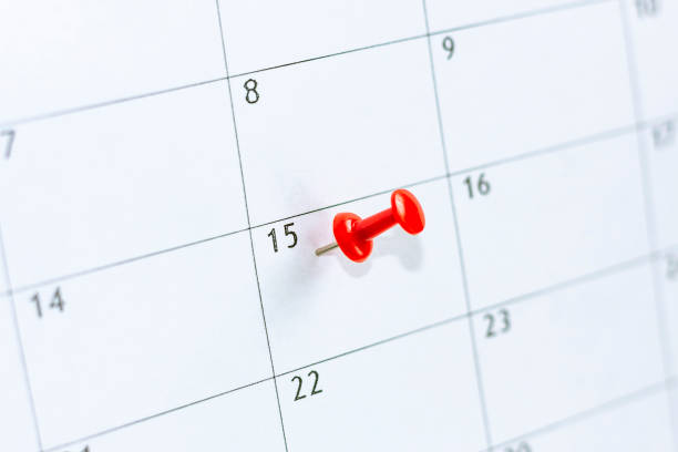 15 date pinning on calendar with Red color pin thumbtack. Save the Date. concept tax day. 15 date pinning on calendar with Red color pin thumbtack. Save the Date. concept tax day. circa 15th century stock pictures, royalty-free photos & images