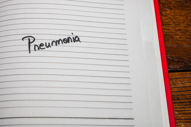 istock Pneumonia, handwriting text on page of office agenda. Copy space. 1201168451
