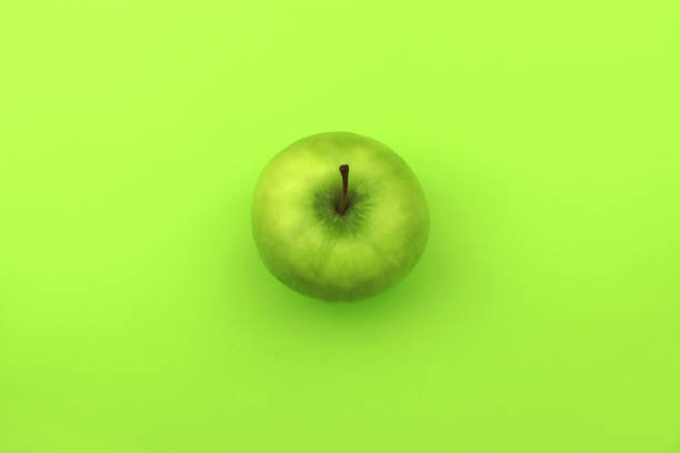 istock green apple on a green background 1201172408