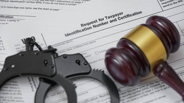 istock tax form with gavel and handcuffs 1201172542
