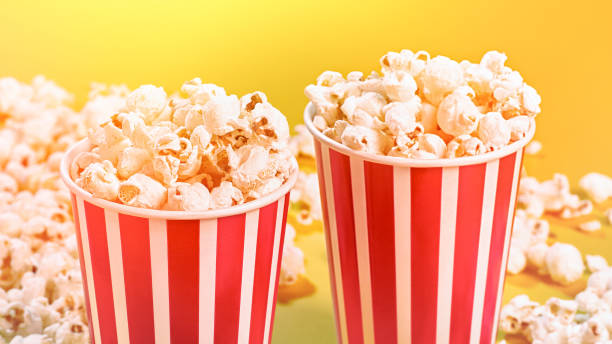 istock Closeup of two red paper baskets with popcorn 1201172727