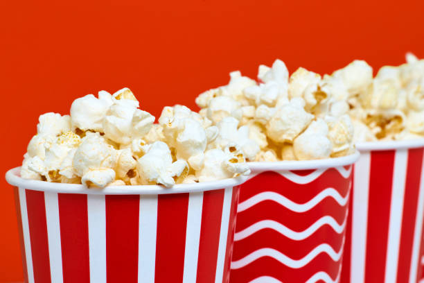 istock Closeup of several red paper baskets with popcorn 1201172728