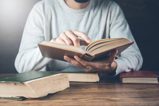 istock man reading book on the wooden desk 1201172928