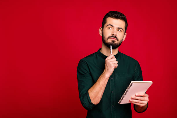 istock Portrait of minded guy write article in his copybook think thoughts look copyspace wear modern stylish outfit isolated over bright color background 1201173531