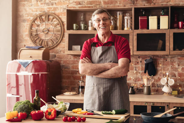 istock Handsome senior man cooking healthy dinner at kitchen 1201175441