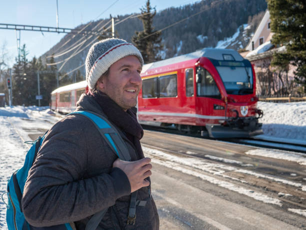 istock Young man waiting for train at station in Winter 1201176860