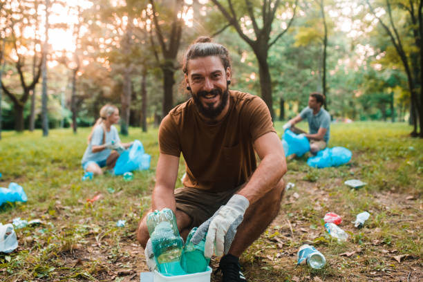 istock Young activist cleaning the park from the garbage 1201177263