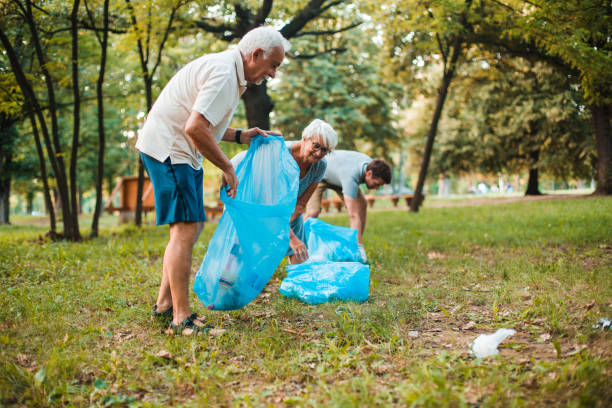 istock Seniors taking part in organized cleaning the park 1201177266
